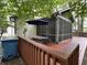 Large deck with a table and a patio umbrella, situated next to the screened porch at 5010 Melbourne Rd, Indianapolis, IN 46228