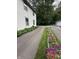 Long driveway flanked by lush greenery and flowerbeds at 5010 Melbourne Rd, Indianapolis, IN 46228