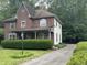 Two-story home with a mix of brick and siding, featuring a lovely front porch at 5010 Melbourne Rd, Indianapolis, IN 46228