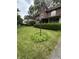 Beautiful brick home with arched windows, lush green lawn, and well-maintained landscaping in a suburban neighborhood at 5010 Melbourne Rd, Indianapolis, IN 46228