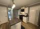 Kitchen view showcasing granite countertops, stainless steel appliances, and white cabinetry at 5010 Melbourne Rd, Indianapolis, IN 46228