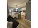 Open-concept kitchen with white cabinets, stainless steel appliances, and hardwood floors at 5010 Melbourne Rd, Indianapolis, IN 46228