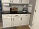 Kitchen counter with white cabinets, black countertop, and subway tile backsplash at 5010 Melbourne Rd, Indianapolis, IN 46228
