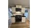 Kitchen featuring stainless steel gas range, microwave, and white cabinets at 5010 Melbourne Rd, Indianapolis, IN 46228
