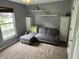 Cozy living room with a plush sofa, bright window, and built-in shelving creating a relaxing space at 5010 Melbourne Rd, Indianapolis, IN 46228