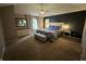 A primary bedroom showcasing the king bed, bench at foot of bed, and ensuite bathroom at 5010 Melbourne Rd, Indianapolis, IN 46228