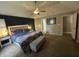 A primary bedroom showcasing the king bed, bench at foot of bed, and attached ensuite bathroom at 5010 Melbourne Rd, Indianapolis, IN 46228