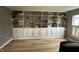 Spacious home office featuring extensive built-in shelving and laminate flooring at 5010 Melbourne Rd, Indianapolis, IN 46228