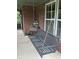 Relaxing porch swing on a brick-accented porch, inviting comfort at 5010 Melbourne Rd, Indianapolis, IN 46228