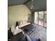 Well-appointed screened porch with seating, a modern table, and access to the outdoor deck and backyard at 5010 Melbourne Rd, Indianapolis, IN 46228