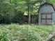 View of the shed surrounded by lush greenery on the property at 5010 Melbourne Rd, Indianapolis, IN 46228