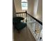 Staircase with modern black and white railings leads to a naturally lit landing with stylish chair at 5010 Melbourne Rd, Indianapolis, IN 46228