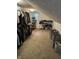 A large walk-in closet showing clothing racks, shoe shelves, and a built-in storage at 5010 Melbourne Rd, Indianapolis, IN 46228