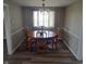 Inviting dining room with classic wood table, chandelier, and neutral wall colors at 520 E County Road 500 S, Muncie, IN 47302