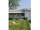 Charming single-story home featuring a well-maintained lawn and awning-covered entry at 520 E County Road 500 S, Muncie, IN 47302