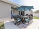 Patio featuring a dining set under a large umbrella, ideal for outdoor meals and entertaining at 5755 Victory Dr, Columbus, IN 47203