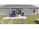 Backyard showcasing a patio with an outdoor dining set, a grill, and green grass at 5755 Victory Dr, Columbus, IN 47203