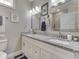 Bathroom featuring double sinks with granite counters and decorative tile flooring, creating a stylish space at 5755 Victory Dr, Columbus, IN 47203