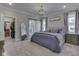 This bedroom features neutral walls, carpeted floors, and closet with a sliding barn door at 5755 Victory Dr, Columbus, IN 47203