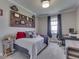 This bedroom features neutral walls, carpeted floors, a desk, and overhead lighting at 5755 Victory Dr, Columbus, IN 47203