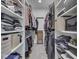 This walk-in closet features white shelves and rods for clothing storage at 5755 Victory Dr, Columbus, IN 47203