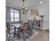 Dining room with wooden table, decor, natural light and stylish chandelier at 5755 Victory Dr, Columbus, IN 47203