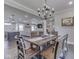 This dining room features a stylish chandelier and flows into an open-concept kitchen and living area at 5755 Victory Dr, Columbus, IN 47203