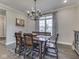 Dining room with wooden table, decor, natural light and stylish chandelier at 5755 Victory Dr, Columbus, IN 47203