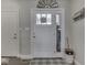 Inviting foyer featuring a white front door with glass inserts, grey rug, and light grey walls at 5755 Victory Dr, Columbus, IN 47203