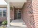 Covered front porch with brick columns and decorative accents, creating a welcoming entrance at 5755 Victory Dr, Columbus, IN 47203