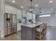 Bright kitchen featuring stainless steel appliances, white cabinets, a center island, and stylish pendant lighting at 5755 Victory Dr, Columbus, IN 47203