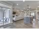 Open-concept living room showcasing a fireplace, coffered ceiling and seamless flow to the kitchen and outdoor patio at 5755 Victory Dr, Columbus, IN 47203