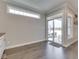 Bright living room features sliding glass doors to patio, hardwood floors, and natural light at 5755 Victory Dr, Columbus, IN 47203