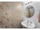 Elegant half-bath featuring decorative wallpaper, a stylish sink and vanity, and modern fixtures at 5794 Wintersweet Ln, Whitestown, IN 46075