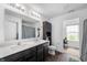 Modern bathroom with double sinks, dark wood cabinets, and stylish fixtures and a walk in closet at 5794 Wintersweet Ln, Whitestown, IN 46075