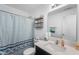 Well-lit bathroom featuring a sink, shower with curtain, a mirror and white cabinets at 5794 Wintersweet Ln, Whitestown, IN 46075