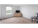 Cozy bedroom featuring a large window, dresser, TV, and chair at 5794 Wintersweet Ln, Whitestown, IN 46075