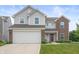 Charming two-story home with a combination of siding and brick exterior with a two car garage at 5794 Wintersweet Ln, Whitestown, IN 46075