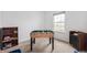 Bright game room with a foosball table, bookshelf, modern dresser, and a view from the window at 5794 Wintersweet Ln, Whitestown, IN 46075