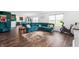 Open concept living room with dark wood flooring, view to Kitchen and outdoor green space at 5794 Wintersweet Ln, Whitestown, IN 46075