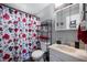Bright bathroom with a floral shower curtain and modern sink vanity at 614 Belzer Dr, Anderson, IN 46011