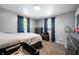 Neutral bedroom with Queen bed, two windows with curtains, and carpeted floor at 614 Belzer Dr, Anderson, IN 46011