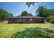 Exterior view of a brick home with a well-maintained lawn at 614 Belzer Dr, Anderson, IN 46011