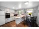 Well-lit eat-in kitchen with light-colored cabinetry and neutral colored countertops at 614 Belzer Dr, Anderson, IN 46011