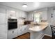 Bright eat-in kitchen featuring light-colored cabinetry and neutral colored countertops at 614 Belzer Dr, Anderson, IN 46011
