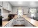 U-shaped kitchen features light colored cabinets and hardware floors at 614 Belzer Dr, Anderson, IN 46011