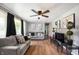 Inviting living room boasts hardwood floors, ceiling fan, and neutral gray colored walls at 614 Belzer Dr, Anderson, IN 46011