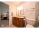 Bathroom features a single vanity, toilet, and doorway leading into an adjacent bedroom at 6408 Old Mill Dr, Indianapolis, IN 46221
