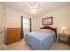 Bedroom features a ceiling fan, queen bed, carpeted floor, dresser, and night stand at 6408 Old Mill Dr, Indianapolis, IN 46221