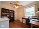 Bedroom with built in shelving, desk, wood floor, and a large window at 6408 Old Mill Dr, Indianapolis, IN 46221
